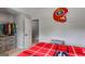 Bedroom boasts red plaid bedding and a Georgia Bulldogs helmet wall decoration at 127 Grayson Myers Dr, Villa Rica, GA 30180