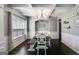 Elegant dining room with dark wood floors, wainscoting, coffered ceiling, and modern chandelier at 127 Grayson Myers Dr, Villa Rica, GA 30180