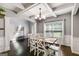 Elegant dining room with dark wood floors, wainscoting, coffered ceiling, and a view to outside at 127 Grayson Myers Dr, Villa Rica, GA 30180