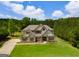 Beautiful two-story home with lush lawn and mature trees, basketball hoop, and manicured lawn at 127 Grayson Myers Dr, Villa Rica, GA 30180
