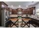 Well-equipped kitchen with dark cabinetry, stainless steel fridge, and a center island at 127 Grayson Myers Dr, Villa Rica, GA 30180