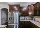 Stainless steel refrigerator with water dispenser and dark wood cabinets in kitchen at 127 Grayson Myers Dr, Villa Rica, GA 30180