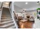Inviting living room with a fireplace, staircase, hardwood floors and neutral color palette at 127 Grayson Myers Dr, Villa Rica, GA 30180