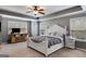 Spacious main bedroom with a tray ceiling, ceiling fan, neutral decor, and an inviting color palette at 127 Grayson Myers Dr, Villa Rica, GA 30180