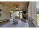 Inviting screened-in porch with wood ceiling, fan, fireplace, and a view of the backyard at 127 Grayson Myers Dr, Villa Rica, GA 30180