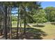 Scenic view of the private backyard with mature trees and lush landscaping at 176 Fairoaks Cir, Stockbridge, GA 30281