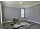 Spacious room with neutral walls, white trim, decorative rug, and ample natural light through the window at 176 Fairoaks Cir, Stockbridge, GA 30281