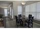 Bright breakfast nook with four chairs, a table, and natural light from the large window with blinds at 176 Fairoaks Cir, Stockbridge, GA 30281