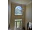 Bright foyer with high ceilings, large arched window, stylish chandelier, and decorative glass front door at 176 Fairoaks Cir, Stockbridge, GA 30281