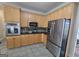 Kitchen with stainless steel appliances, granite counters, tile backsplash, and wood cabinetry at 176 Fairoaks Cir, Stockbridge, GA 30281
