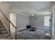 Spacious living room featuring hardwood floors, a ceiling fan, and abundant natural light at 176 Fairoaks Cir, Stockbridge, GA 30281