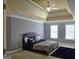 Beautifully designed bedroom with a large bed, tray ceiling, and an abundance of windows at 176 Fairoaks Cir, Stockbridge, GA 30281