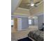 Expansive main bedroom with tray ceiling, ample natural light, and access to a private bath at 176 Fairoaks Cir, Stockbridge, GA 30281