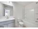 Clean white bathroom with a single sink vanity, toilet, and a tub/shower combination at 1812 Quaker St, Hampton, GA 30228