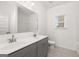 Bathroom featuring double sink vanity with gray cabinets, a large mirror and tile flooring at 1812 Quaker St, Hampton, GA 30228