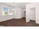 Dining room with dark hardwood floors, large window, and closet storage at 1812 Quaker St, Hampton, GA 30228