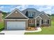 Charming brick home featuring a two-car garage and beautifully landscaped front yard at 1812 Quaker St, Hampton, GA 30228
