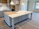 Kitchen island with white countertops, gray cabinets, and modern faucet fixture at 1812 Quaker St, Hampton, GA 30228