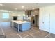 Open-concept kitchen featuring gray cabinets, island with marble countertops, and stainless appliances at 1812 Quaker St, Hampton, GA 30228