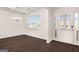Bright living room with dark hardwood floors and an entry door with sidelight windows at 1812 Quaker St, Hampton, GA 30228