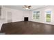 Spacious living room with a fireplace, dark hardwood floors, and natural light at 1812 Quaker St, Hampton, GA 30228