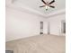 Large main bedroom with ample space, neutral carpet and tray ceiling at 1812 Quaker St, Hampton, GA 30228