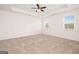 Spacious main bedroom featuring plush carpet, tray ceiling and natural light at 1812 Quaker St, Hampton, GA 30228