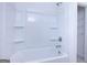 Clean, bright white shower and tub combination with built-in shelving at 1812 Quaker St, Hampton, GA 30228