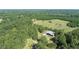 Birds-eye view of a property featuring a barn, mature trees, and a peaceful setting at 2371 Leguin Mill Rd, Locust Grove, GA 30248