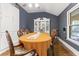 Dining room with hardwood floors, a ceiling fan, and blue painted walls at 2371 Leguin Mill Rd, Locust Grove, GA 30248