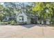 Exterior view of home with side entrance, partial driveway, and mature landscaping at 2371 Leguin Mill Rd, Locust Grove, GA 30248