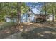Charming home with light blue siding, a garage, and a covered porch with natural surroundings at 2371 Leguin Mill Rd, Locust Grove, GA 30248