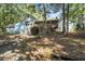 Charming home with light blue siding, a garage, and a covered porch surrounded by natural beauty at 2371 Leguin Mill Rd, Locust Grove, GA 30248