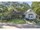 Charming single-story home with a lush front lawn and mature trees under a clear blue sky at 2371 Leguin Mill Rd, Locust Grove, GA 30248
