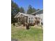 A beautiful outdoor greenhouse with wood framing on a sunny day at 2371 Leguin Mill Rd, Locust Grove, GA 30248