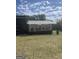 View of greenhouse exterior on a grassy lawn with a blue sky at 2371 Leguin Mill Rd, Locust Grove, GA 30248