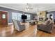 Spacious living room featuring hardwood floors, fireplace, and large windows at 2371 Leguin Mill Rd, Locust Grove, GA 30248