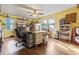 Bright home office with multiple windows, hardwood flooring, and a ceiling fan at 2371 Leguin Mill Rd, Locust Grove, GA 30248