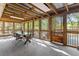 Screened sunroom with a large table, chairs, and natural light at 2371 Leguin Mill Rd, Locust Grove, GA 30248