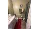 Bathroom featuring a white vanity, toilet, and olive green walls at 6444 Charter Way, Lithonia, GA 30058