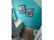 Charming powder room with modern fixtures and vanity and bright teal walls at 6444 Charter Way, Lithonia, GA 30058