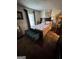 Cozy bedroom with floral bedding, decorative bench, and window at 6444 Charter Way, Lithonia, GA 30058