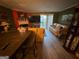 Bright living room featuring laminate wood floors, fireplace and sliding glass door to outside deck at 6444 Charter Way, Lithonia, GA 30058