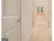 Hallway view of a neutral-toned bathroom with carpeted floor and bathtub at 115 Edgewood Pkwy, Fayetteville, GA 30215