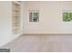 Bright bedroom featuring neutral carpet, natural light, and built-in shelving at 115 Edgewood Pkwy, Fayetteville, GA 30215