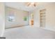 Bright bedroom features neutral carpet, large windows, and built-in shelving at 115 Edgewood Pkwy, Fayetteville, GA 30215