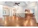 Open-concept living room with hardwood floors, columns, and easy access to the kitchen and dining areas at 115 Edgewood Pkwy, Fayetteville, GA 30215