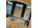 Luxurious bathroom featuring a soaking tub with tiled surround and three large windows for natural light at 119 Glen Eagle Way, Mcdonough, GA 30253