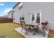 Outdoor patio with dining set, grill, and lush green grass with wood fence, ideal for summer gatherings at 5396 Pennington Ct, South Fulton, GA 30349