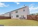 Spacious backyard with green grass, wood fence, patio, and outdoor dining set, perfect for entertaining guests at 5396 Pennington Ct, South Fulton, GA 30349